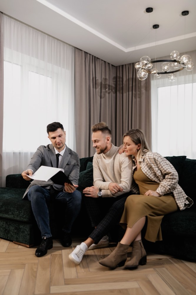 Business owner walking a couple through the plan for their project